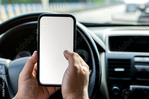 mockup of a mobile phone in your hand while driving a car . The windshield shows the way