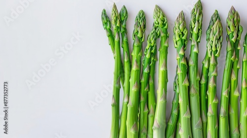 Fresh asparagus spears, vibrant green, isolated white background, copy space