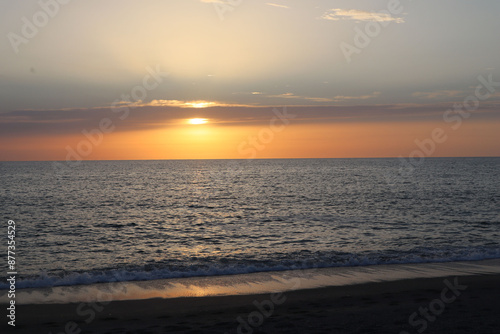 Sunset over the sea on a summer evening on the beach in Calabria