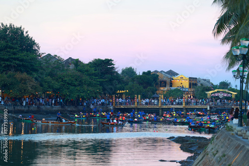 the lantern boats on the thu bon river or canal  in hoi an night market in vietnam at evening with the townscape of Hoi An old town