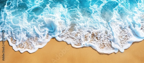Close up view of pristine beach showing blue sea white foam and yellow sand ideal for holiday themes with copy space image backdrop