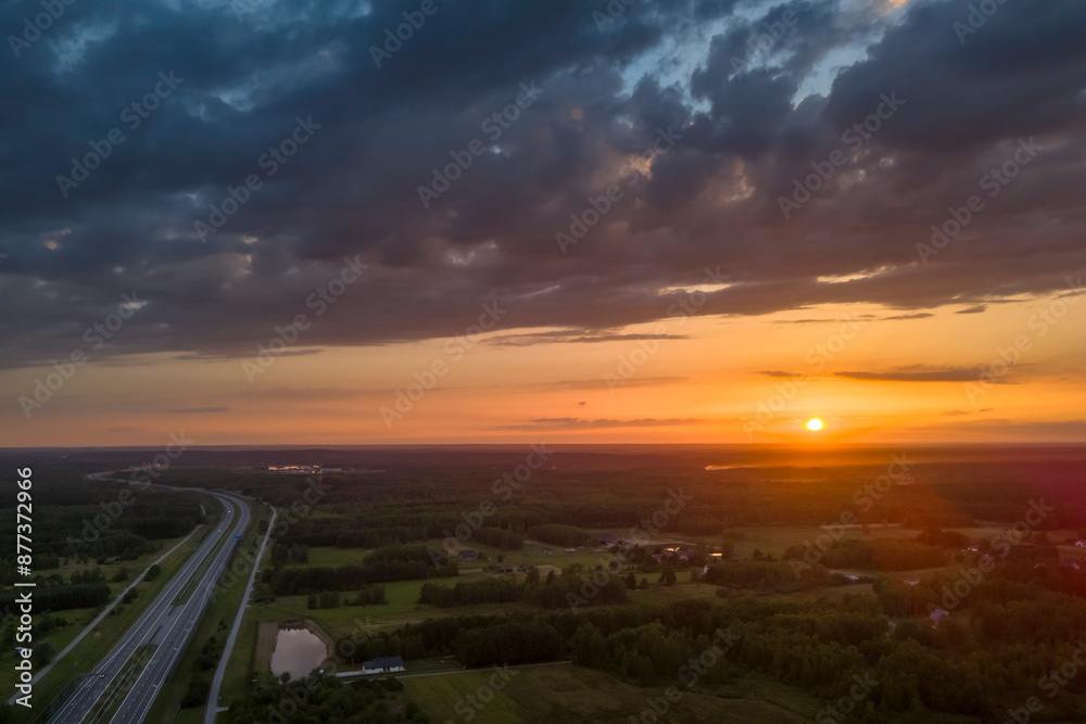 Aerial view of the highway, bridge and sunset on the horizon. Travel, transportation and road and highway construction concept Aerial view of the highway, bridge and sunset on the horizon. Travel, transportation and road and highway construction concept