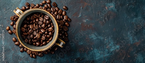 A top down view showing numerous coffee beans in a ceramic mug with space for text or images. Copy space image. Place for adding text and design