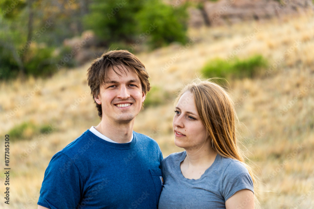 Couple enjoys outdoor moment in a serene natural landscape during sunset while capturing a special memory together Couple enjoys outdoor moment in a serene natural landscape during sunset while capturing a special memory together