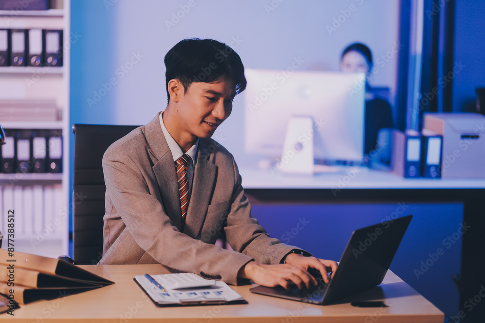 Fototapeta premium Modern young man working remotely from home at night.
