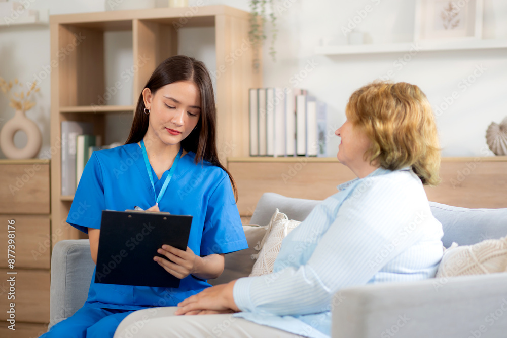 Caregiver sitting on sofa checkup and diagnostic with elderly woman patient about health in living room at home, caretaker sitting on couch explaining and examining senior, insurance and medical. Caregiver sitting on sofa checkup and diagnostic with elderly woman patient about health in living room at home, caretaker sitting on couch explaining and examining senior, insurance and medical.