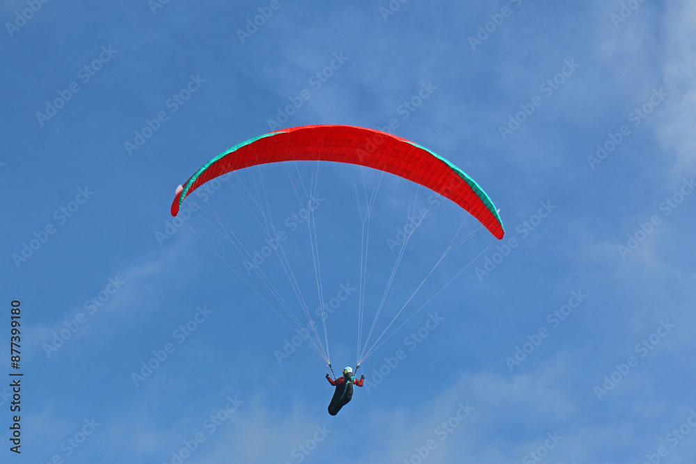 Paraglider flying in a blue sky Paraglider flying in a blue sky