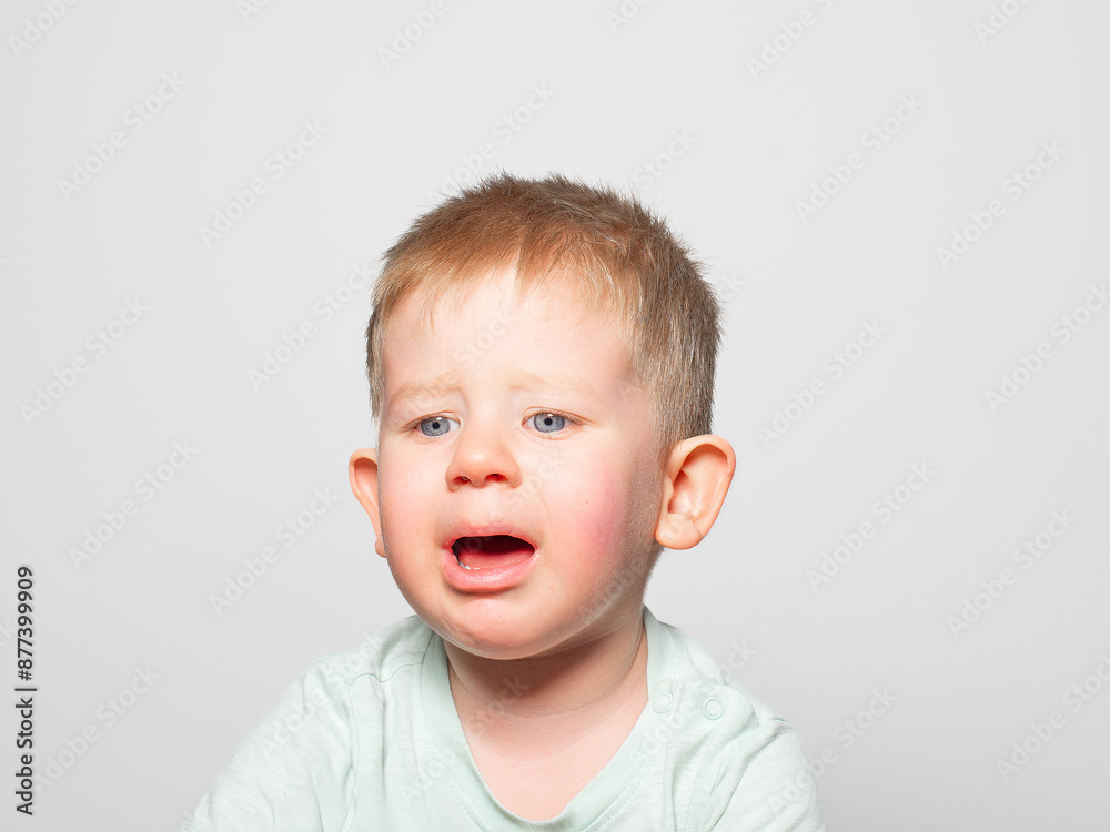 crying baby on a light-colored background crying baby on a light-colored background