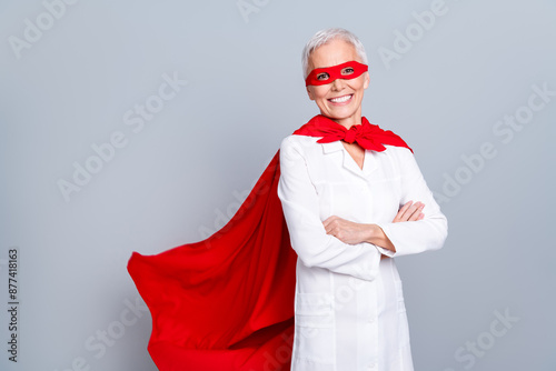 Photo of smiling old lady doctor cross arms wear white coat uniform isolated grey color background