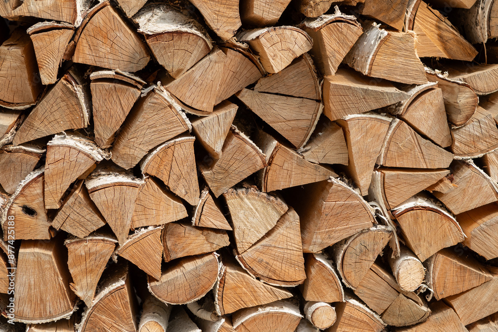Stack of dried firewood from birch wood. Harvesting wood for the winter. Firewood background. Stack of dried firewood from birch wood. Harvesting wood for the winter. Firewood background.