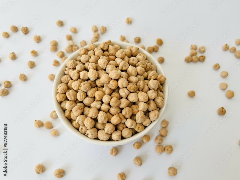 Raw dry chickpea in small ceramic bowl on white background. Traditional ingredient for cooking hummus. Middle Eastern and Mediterranean cuisine. Selected focused Raw dry chickpea in small ceramic bowl on white background. Traditional ingredient for cooking hummus. Middle Eastern and Mediterranean cuisine. Selected focused