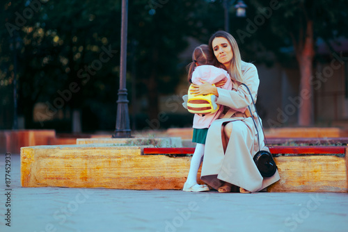 Sad Mother Hugging Girl Going to Preschool . Mum suffering from separation anxiety from her little kid 
