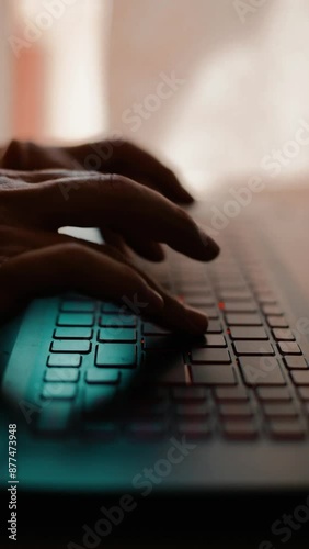 men's hands working on a laptop keyboard