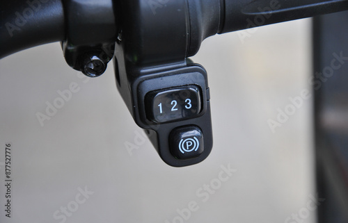 parking brake button and speed mode selection button on an electric bicycle close-up