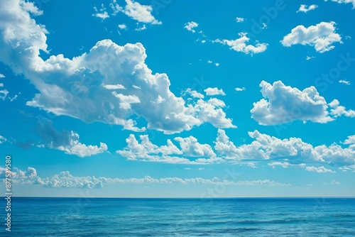 Beautiful blue sky with white clouds is reflecting in the calm sea on a bright sunny day