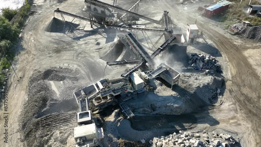 Aerial drone video of Gravel separator machine separates stone material into various fractions. Stone crusher plant machine. Conveyor belt in work process. Extraction of aggregates or gold from river