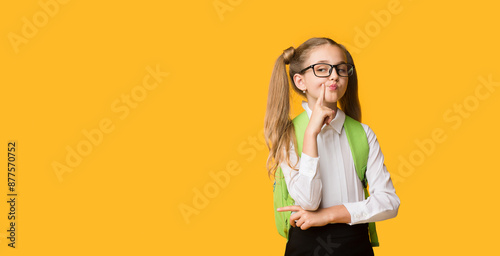 Bild auf Leinwand Funny Elementary Schoolgirl Posing Pretending Being Haughty On Yellow Background