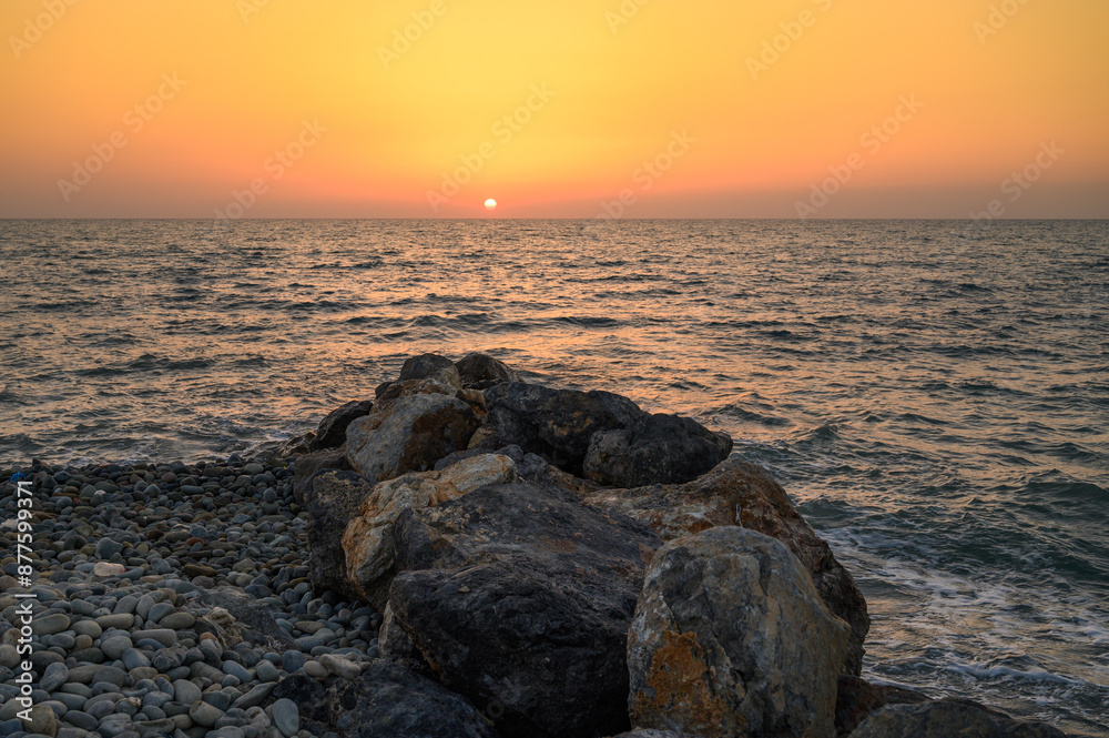 Splendid summer sunset with cloudy sky at rocky Cypriot coast Splendid summer sunset with cloudy sky at rocky Cypriot coast