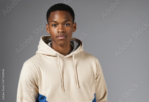 African American man wearing casual attire poses for a photoshoot in a black t-shirt and shorts, showcasing a fashion-forward look with a photogenic appeal