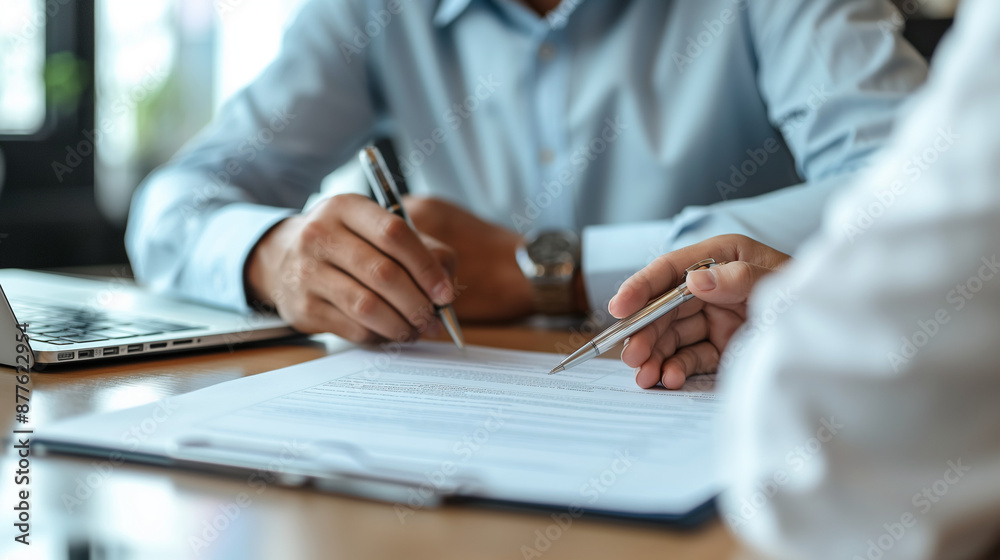bank manager consulting employee reading document at meeting bank manager consulting employee reading document at meeting