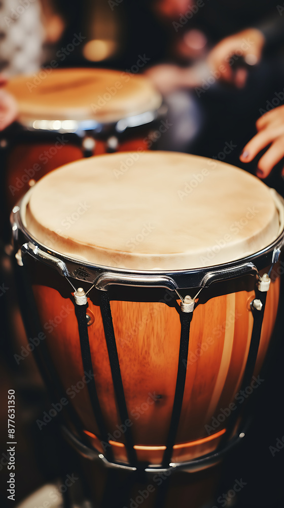 Fototapeta premium Close-up of a wooden bongo drum with brown, black, and silver tones, capturing the essence of musical rhythm and energy. 