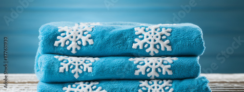 Blue towels with white snowflakes, cozy winter warmth, perfect for a relaxing holiday. 