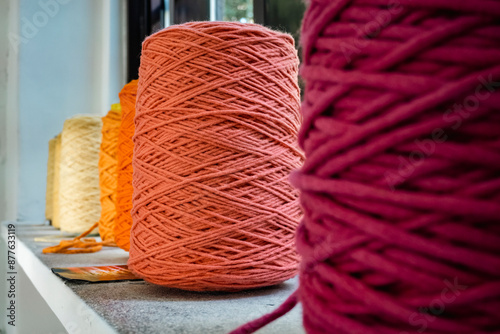 Canvas Print Row of colorful, folded wool fabric placed on window bar
