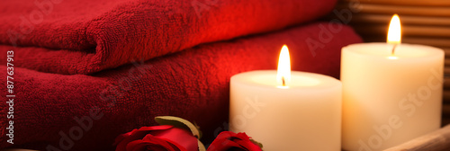 Red towels, candles, and roses, creating a spa-like scene.
