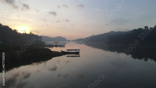 Aerial morning view of Sermo lake and green forest with canopies of spruce trees in Kulonprogo, Yogyakarta, Indonesia. photo