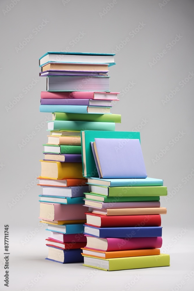 Stacks of colorful books on light grey background Stacks of colorful books on light grey background