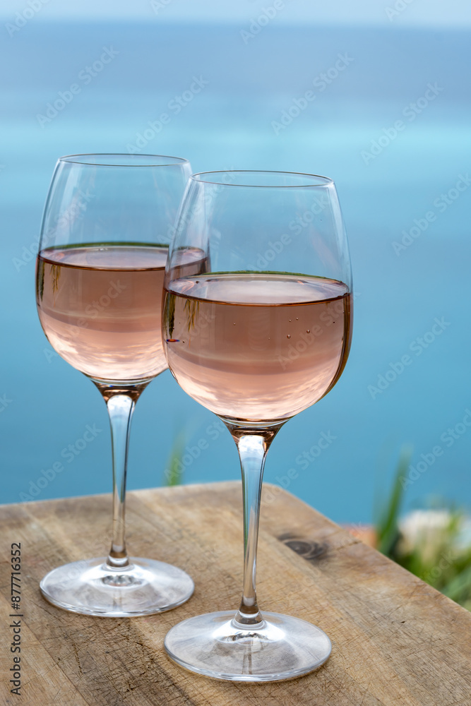 Summer time in Provence, two glasses of cold rose wine with blue sea view on background, French Riviera near Menton, south of France Summer time in Provence, two glasses of cold rose wine with blue sea view on background, French Riviera near Menton, south of France