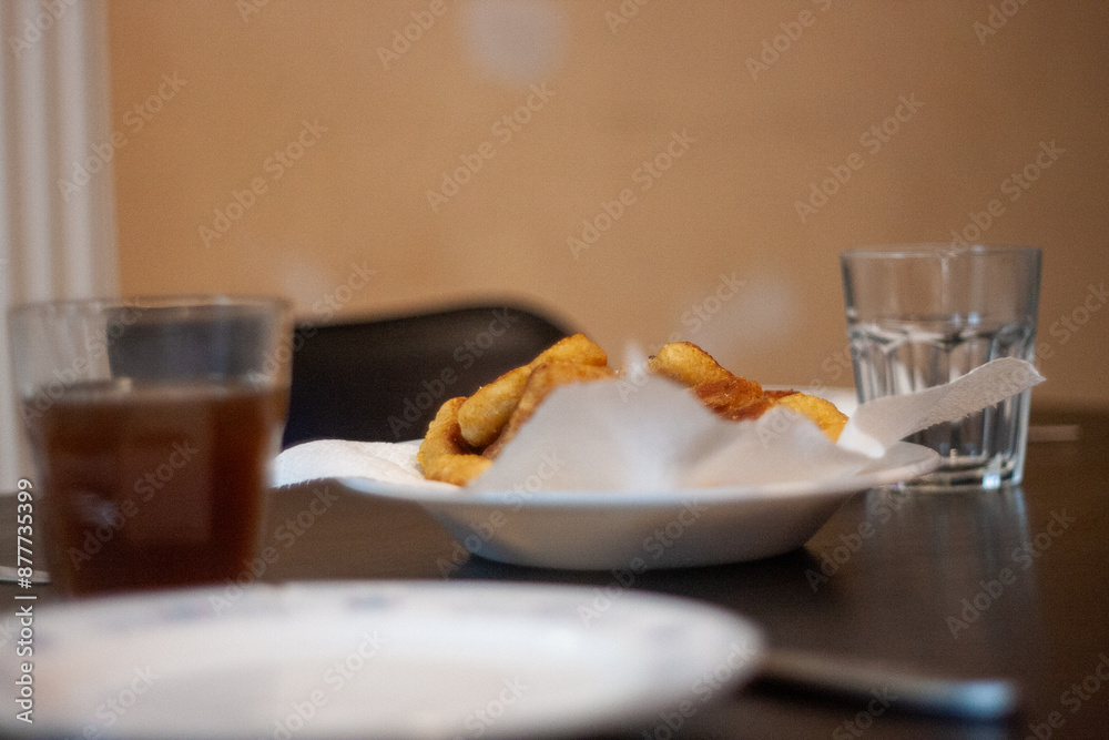 dinner table with chicken nuggets, sausages, fries and salad. dinner table with chicken nuggets, sausages, fries and salad.