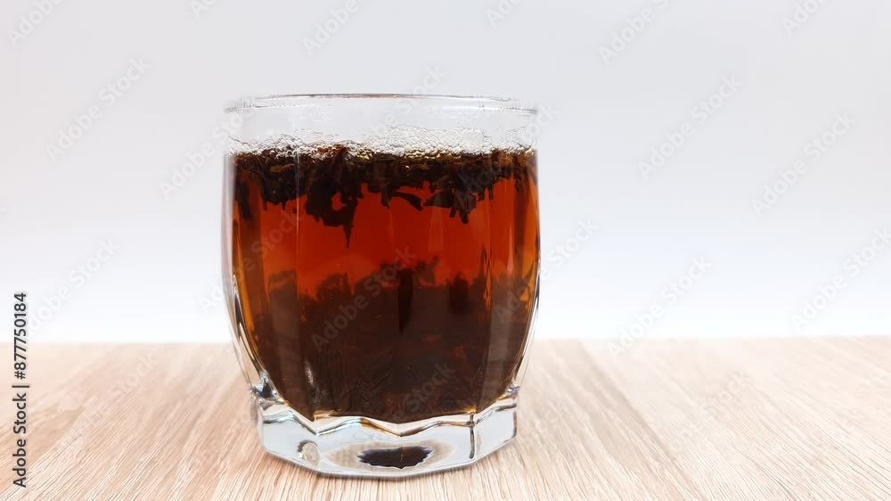 Clear glass of black tea on the table. Brewing natural tea. Clear glass of black tea on the table. Brewing natural tea.