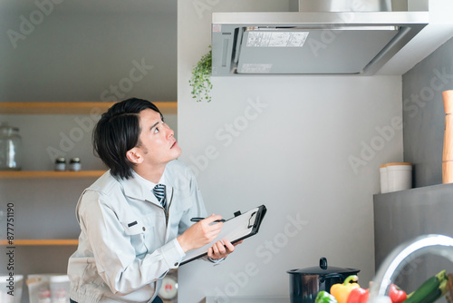 Wallpaper Mural キッチンのレンジフード・換気扇を点検・チェックする作業着姿の男性ビジネスマン
 Torontodigital.ca