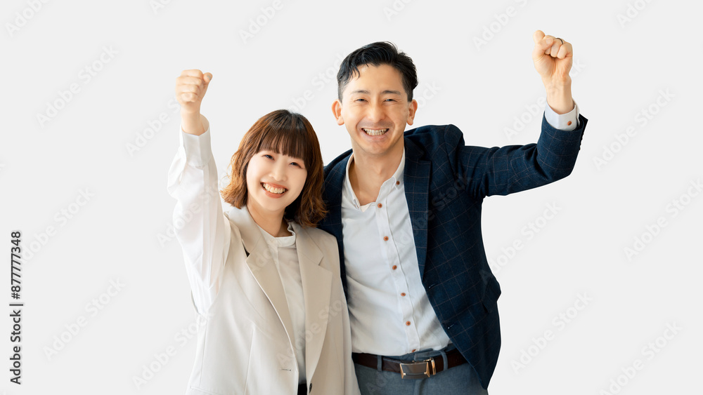 ガッツポーズをする笑顔のビジネスマン男女 ガッツポーズをする笑顔のビジネスマン男女