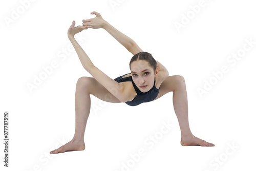 young ballerina in a dark bodysuit sitting on the floor shows stretching and eversion of her arms