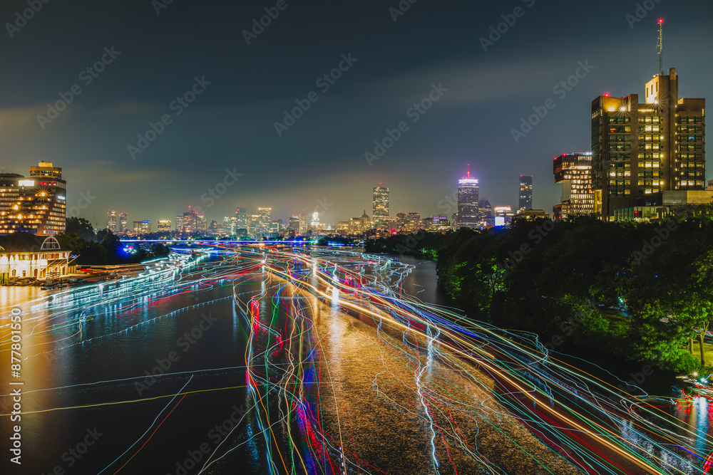 Fototapeta premium Boats and kayaks lighting up Charles River after July 4th fireworks celebration at Boston