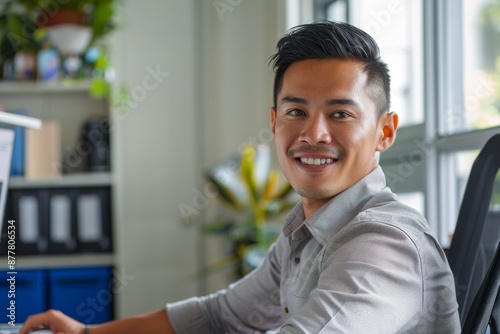 Portrait of confident smiling Asian man sitting at desk Free Download Portrait of confident smiling Asian man sitting at desk - GFXLoad