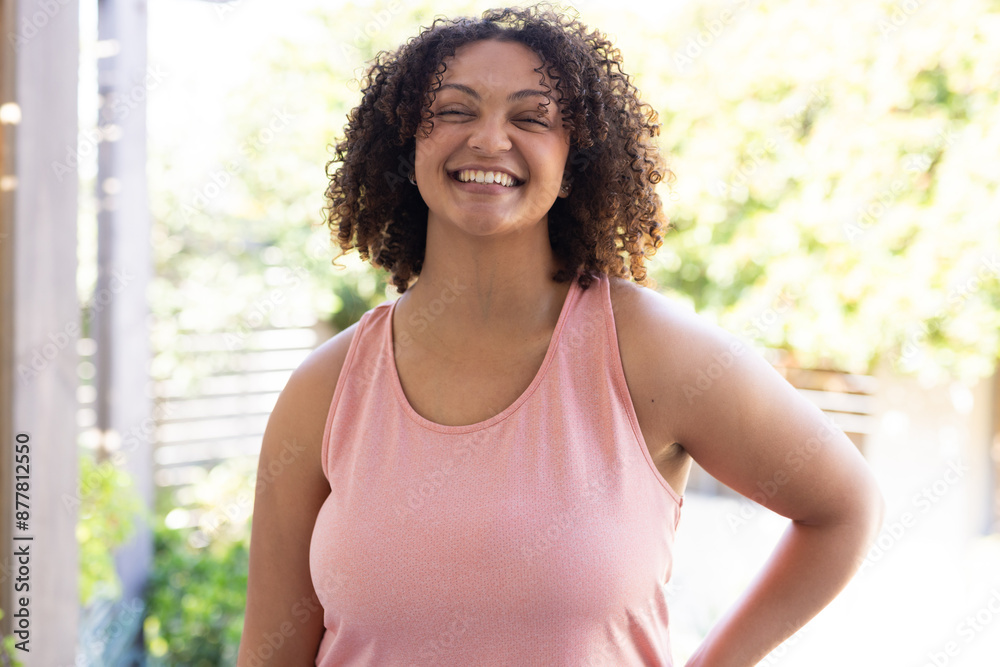 Smiling woman in pink tank top enjoying outdoor time, feeling happy and relaxed Smiling woman in pink tank top enjoying outdoor time, feeling happy and relaxed