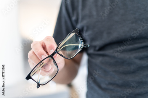 Close up of young man showing eyeglasses