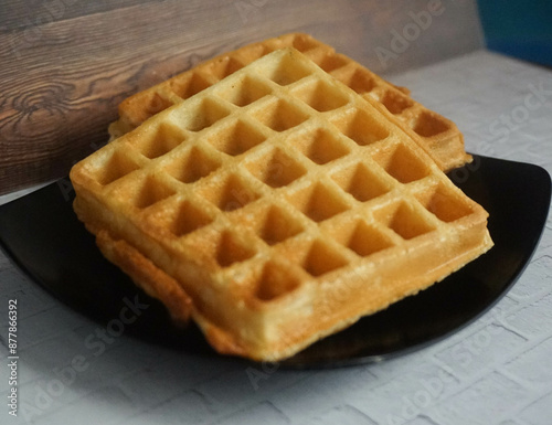 Homemade Waffles, delicious, close up. Waffle is a dish made from leavened batter or dough that is cooked between two plates that are patterned to give a characteristic size, shape, and surface impres