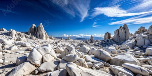 Stunning White Rocky Landscape Under Clear Blue Sky and Clouds