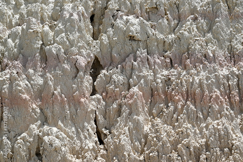 Dry cracks erosion sediment background in Biosphere Reserve Bardenas Reales, Spain, Navarra, Bardena Blanca with mountains, dry earth, stones. photo