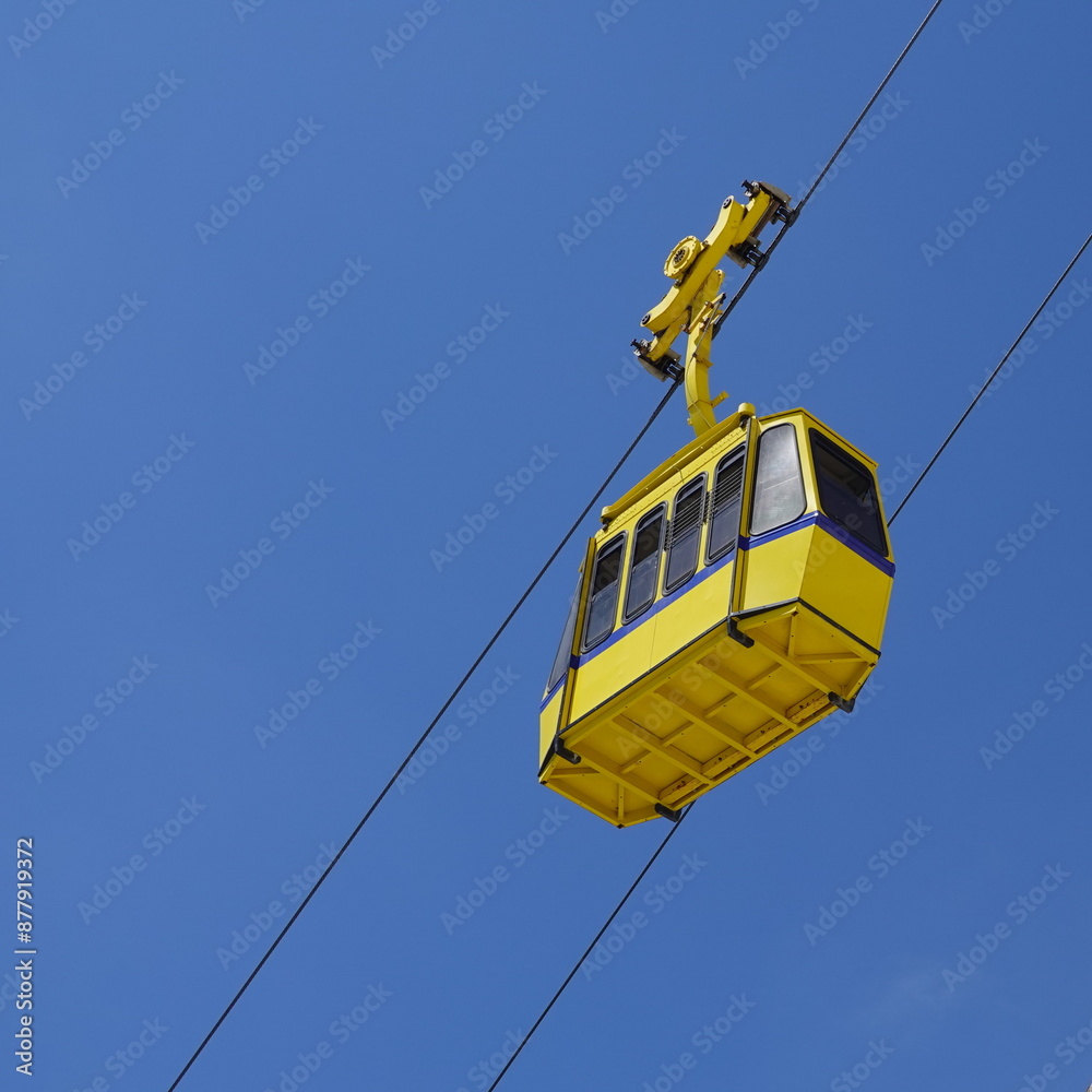 Yellow funicular car against the background of the sky and white rock. Cable road at Rosh Hanikra tourist site. Tourism Concept Yellow funicular car against the background of the sky and white rock. Cable road at Rosh Hanikra tourist site. Tourism Concept