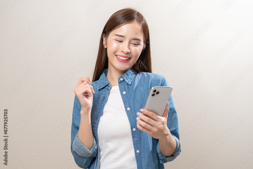 Happy asian young woman using mobile smart phone, read good news online, laugh excited getting offer, great positive surprise, celebrate success on smartphone. Smile girl isolated on white background. Happy asian young woman using mobile smart phone, read good news online, laugh excited getting offer, great positive surprise, celebrate success on smartphone. Smile girl isolated on white background.