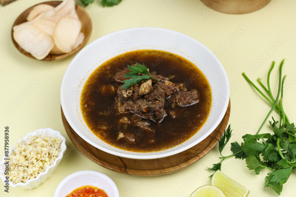 Rawon Daging Sapi or Indonesian beef black soup, traditional beef soup from East Java, served with rice, bean sprouts, sambal, lime, and shrimp crackers. Rawon Daging Sapi or Indonesian beef black soup, traditional beef soup from East Java, served with rice, bean sprouts, sambal, lime, and shrimp crackers.