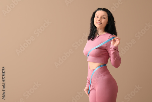 Young woman in pink sportsw...