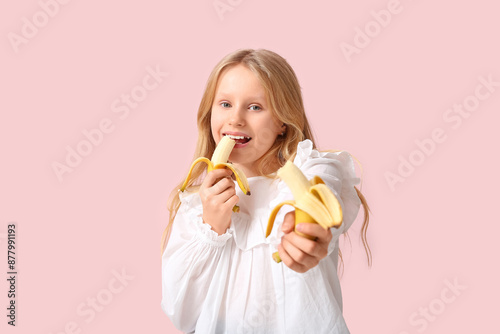 Cute little girl eating tas...