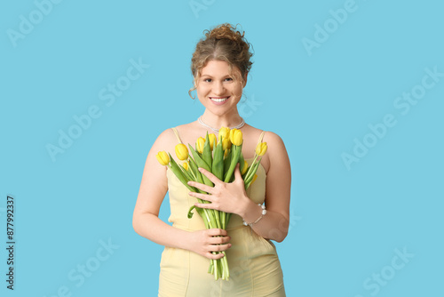 Smiling young woman holding...