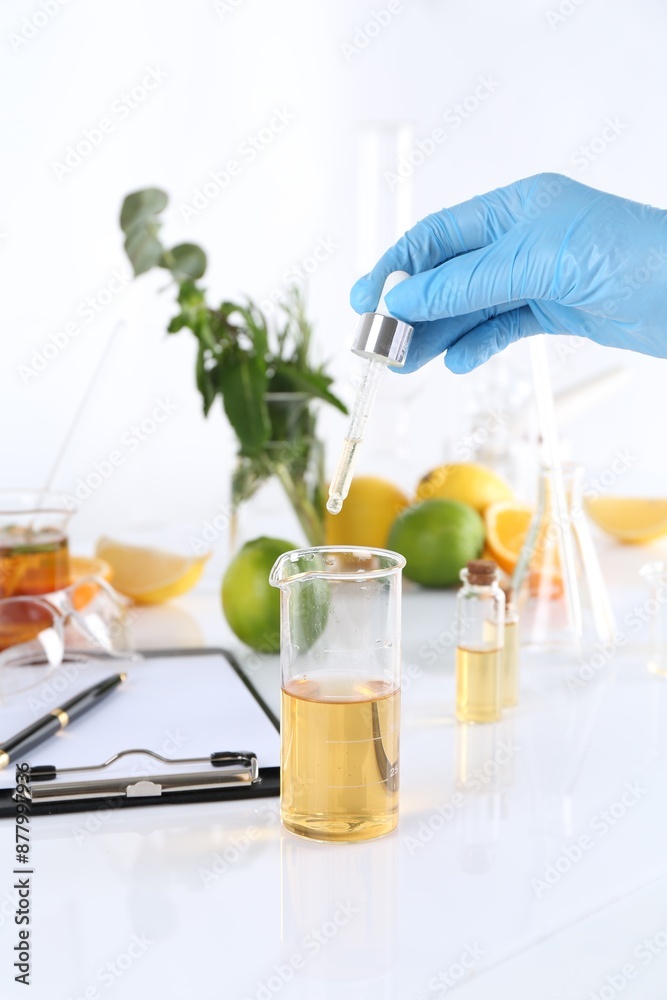 Aromatherapy product. Scientist developing essential oils at white table in laboratory, closeup Aromatherapy product. Scientist developing essential oils at white table in laboratory, closeup